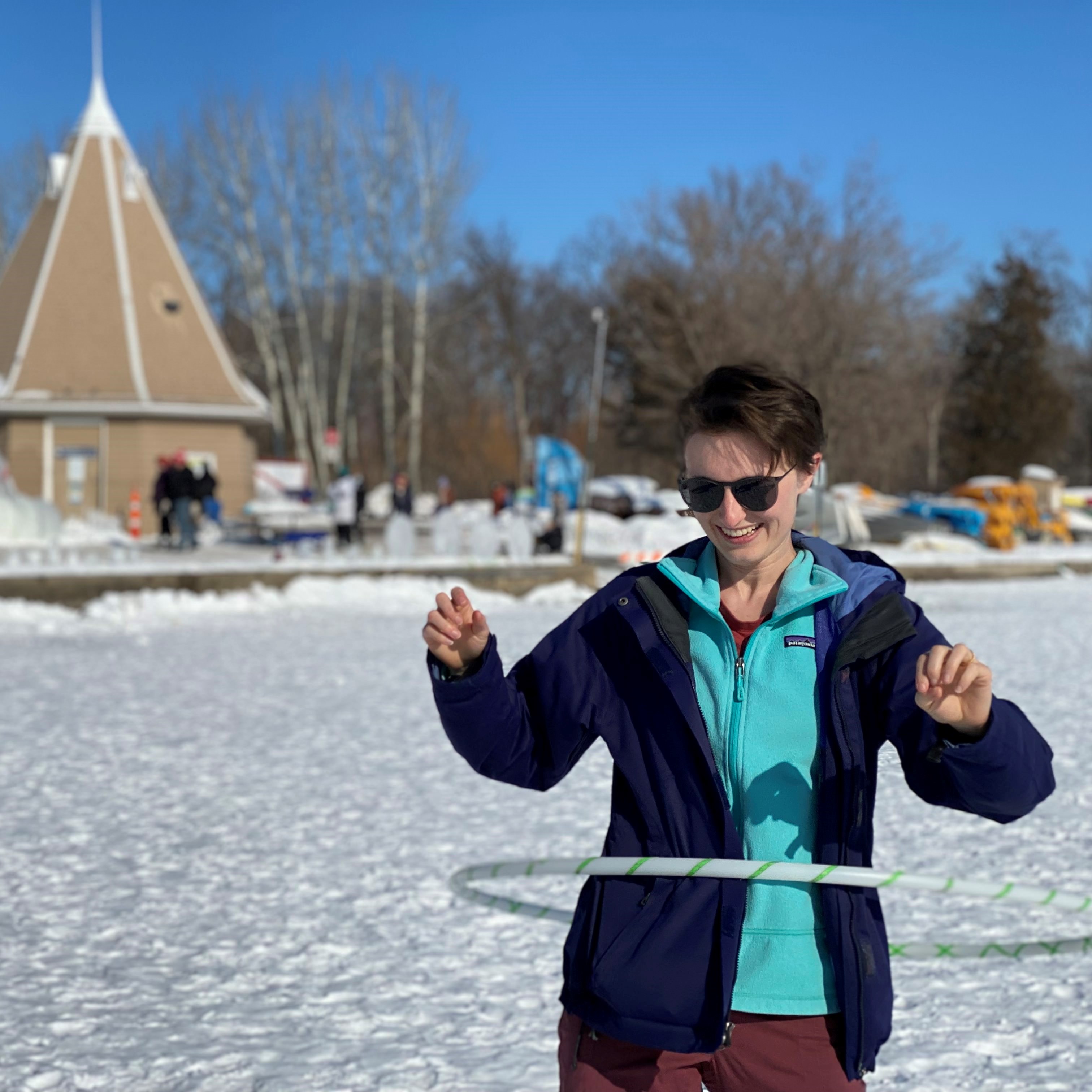Annie enjoying a bright winter day hula hooping on frozen Lake Harriet in Minneapolis